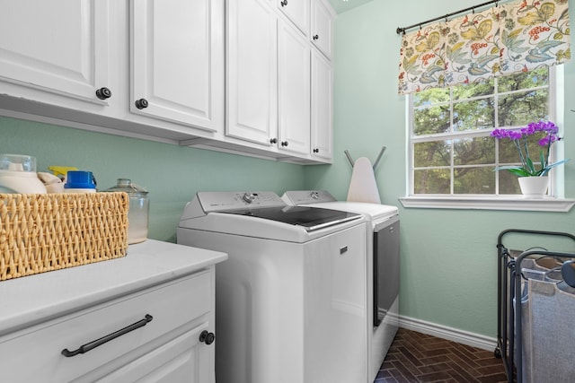 washroom featuring independent washer and dryer and cabinets