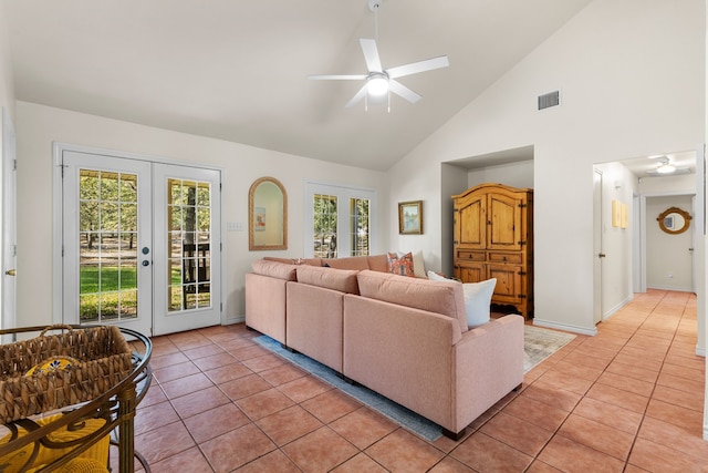 tiled living room with high vaulted ceiling, ceiling fan, and french doors