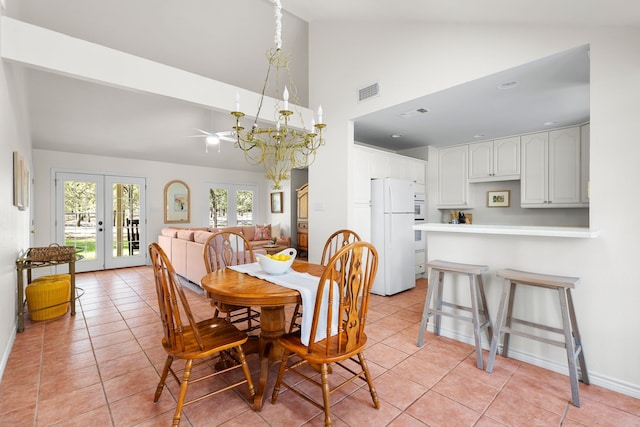 tiled dining room with french doors, high vaulted ceiling, and ceiling fan