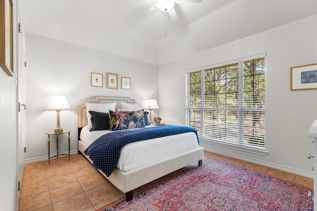 bedroom with ceiling fan and tile patterned flooring