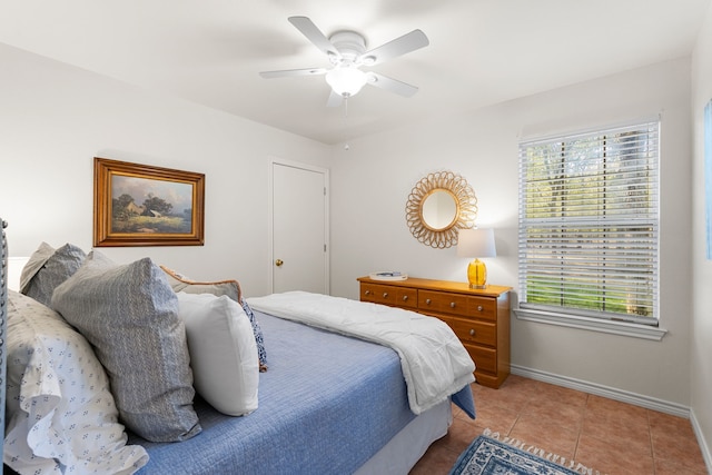 bedroom with ceiling fan and light tile patterned flooring