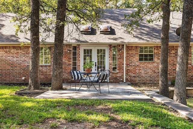 rear view of property featuring french doors and a patio