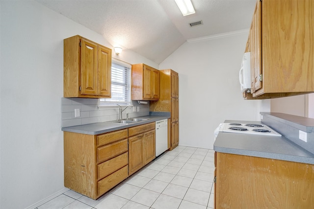 kitchen with sink, light tile patterned floors, white appliances, crown molding, and lofted ceiling