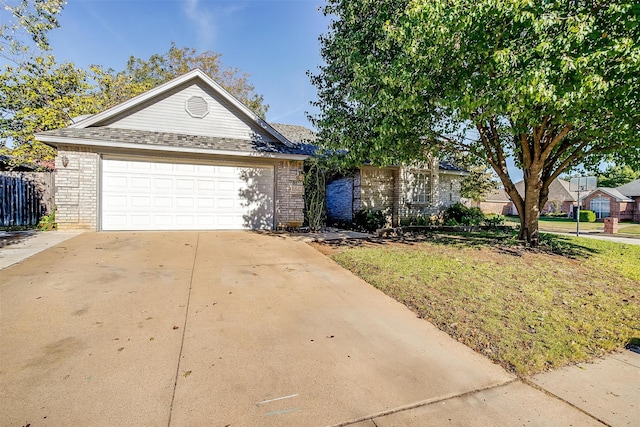 ranch-style home with a garage and a front yard