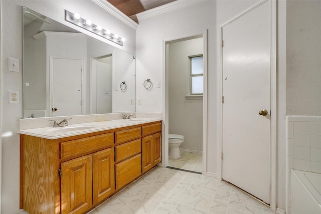 bathroom featuring crown molding, vanity, and toilet