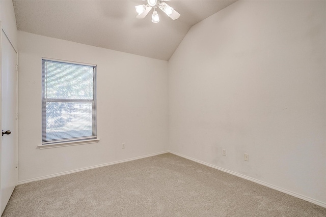 unfurnished room with ceiling fan, vaulted ceiling, and light carpet