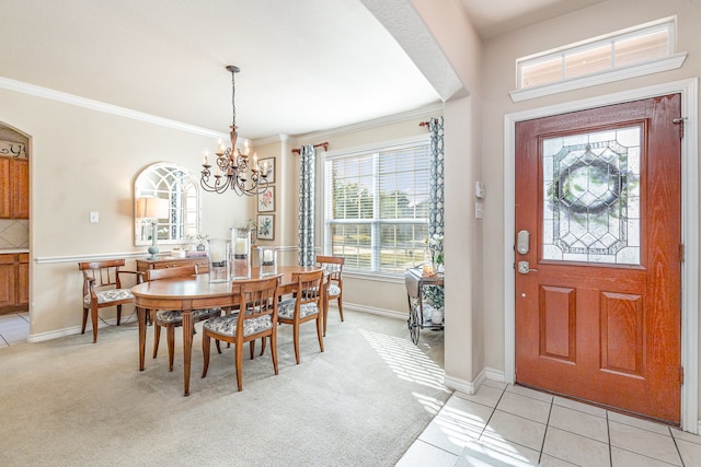 tiled dining space featuring a chandelier and ornamental molding