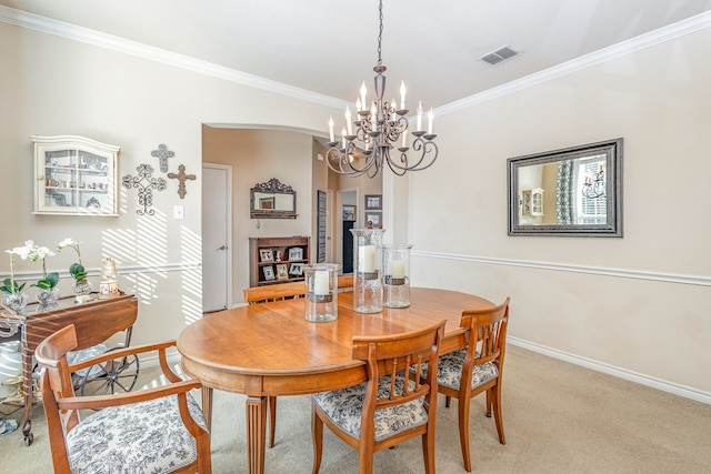 dining area featuring light colored carpet, a notable chandelier, and crown molding