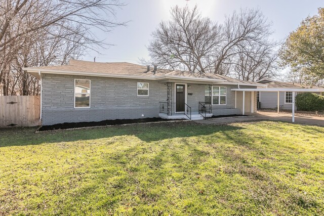 single story home featuring a carport and a front lawn