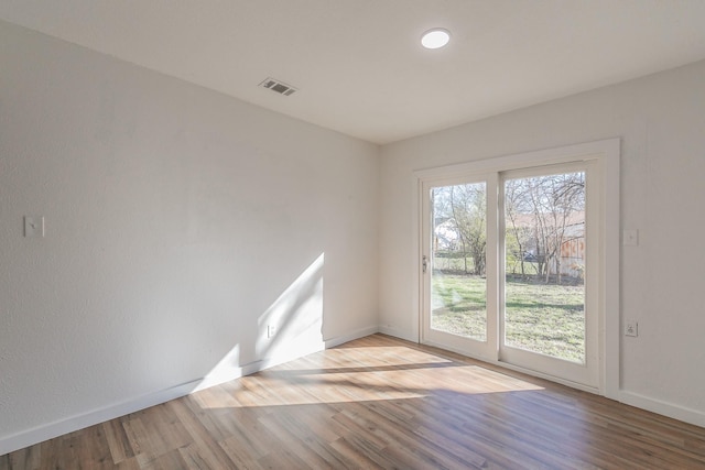 empty room with light hardwood / wood-style floors