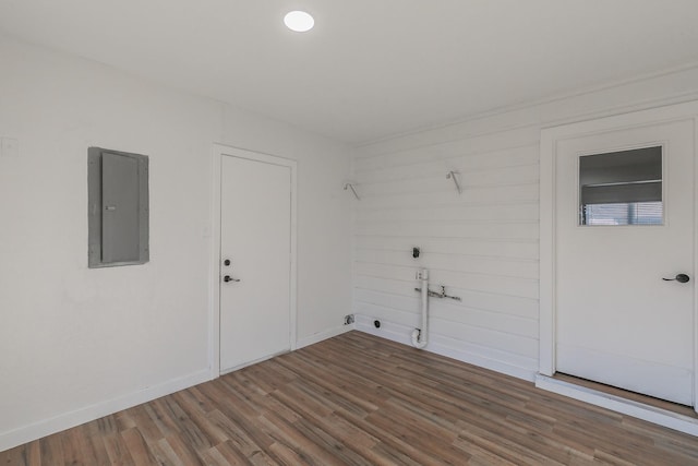 empty room featuring electric panel and hardwood / wood-style floors