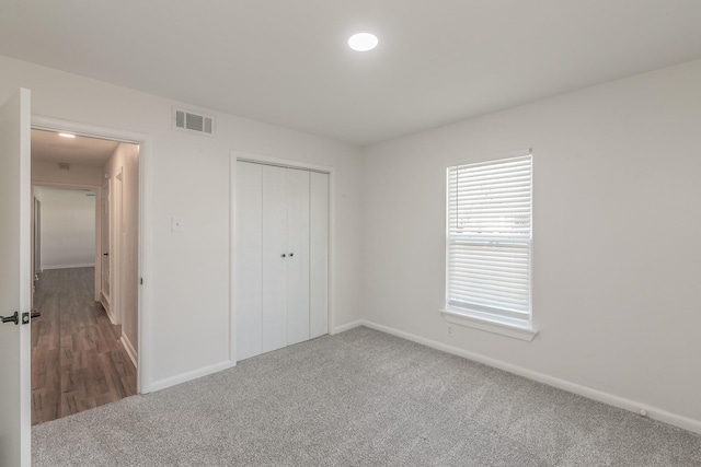 unfurnished bedroom featuring a closet and carpet