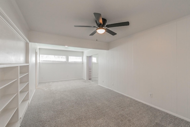 carpeted empty room featuring ceiling fan