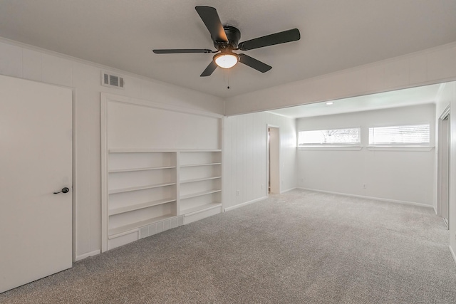 unfurnished bedroom featuring crown molding, ceiling fan, and carpet floors