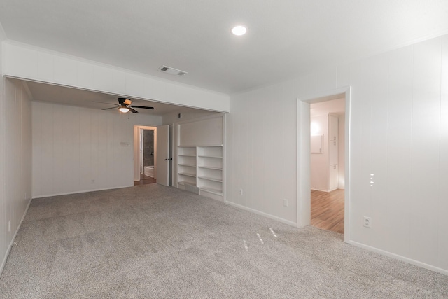 carpeted empty room with ceiling fan and ornamental molding