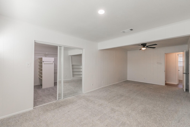 unfurnished bedroom featuring light colored carpet and a closet