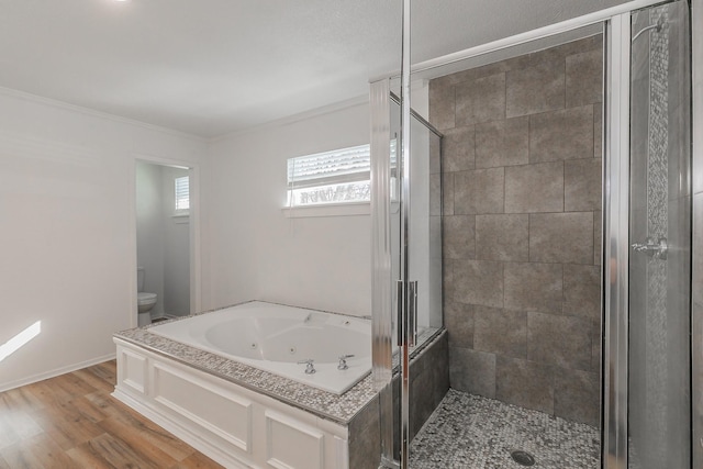 bathroom featuring wood-type flooring, ornamental molding, independent shower and bath, and toilet