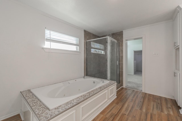 bathroom featuring crown molding, wood-type flooring, and shower with separate bathtub