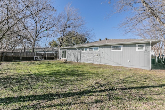 back of property featuring a yard