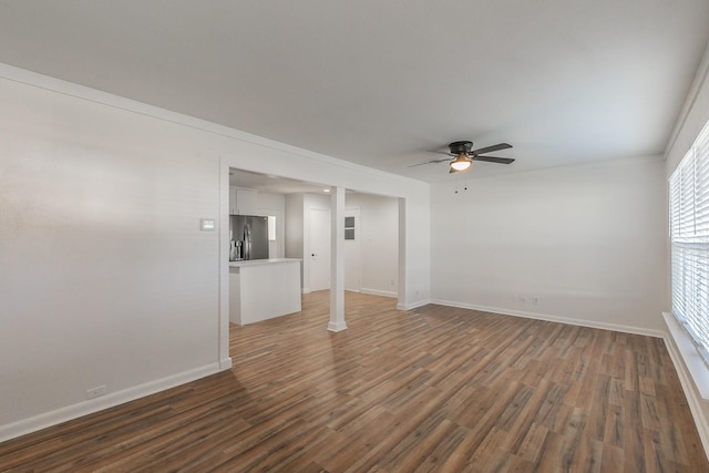 spare room with dark wood-type flooring and ceiling fan