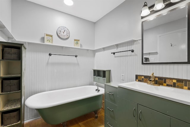 bathroom with vanity, wood-type flooring, and a bath