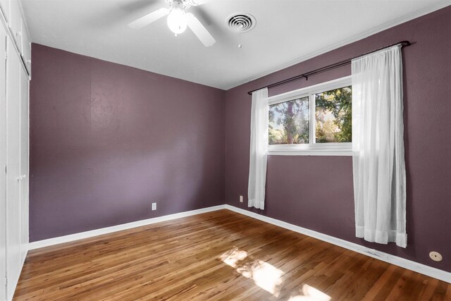 empty room with ceiling fan and wood-type flooring