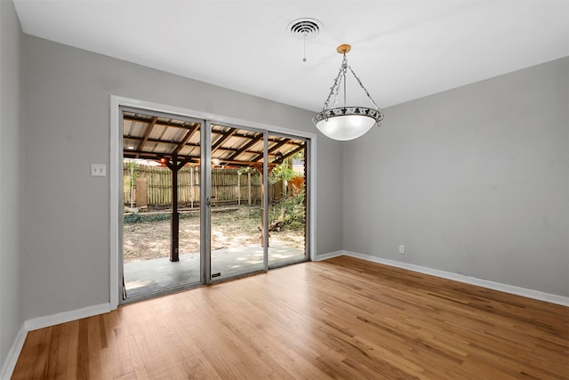 unfurnished dining area featuring wood-type flooring