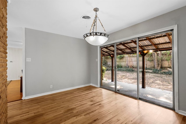 unfurnished dining area featuring wood-type flooring