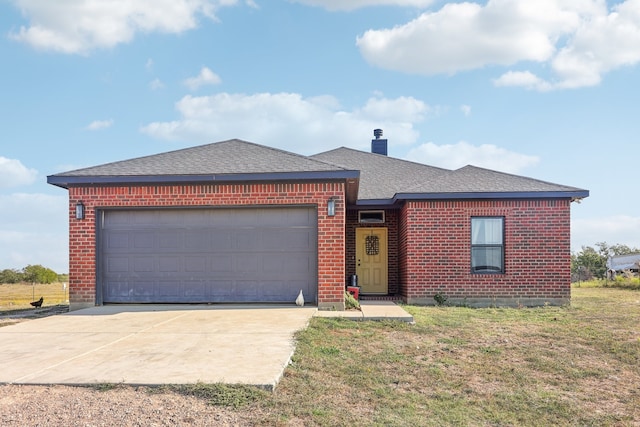 view of front of home with a front yard and a garage