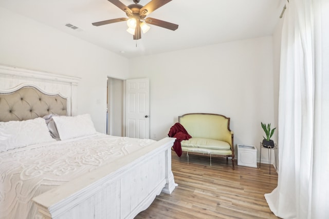 bedroom with ceiling fan and light hardwood / wood-style flooring