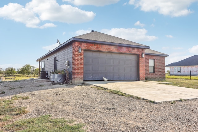 view of home's exterior with central air condition unit and a garage