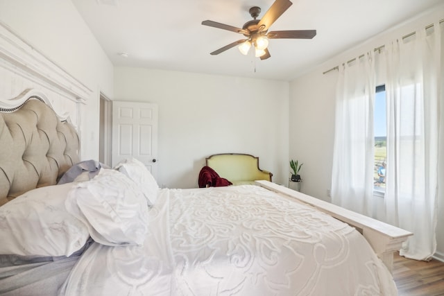 bedroom with hardwood / wood-style flooring and ceiling fan