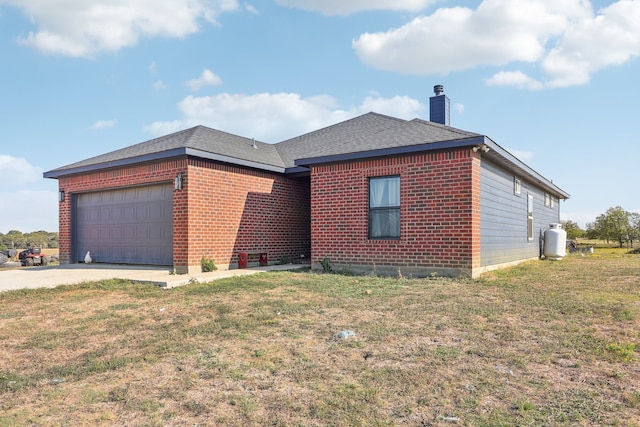 ranch-style home with a garage and a front lawn