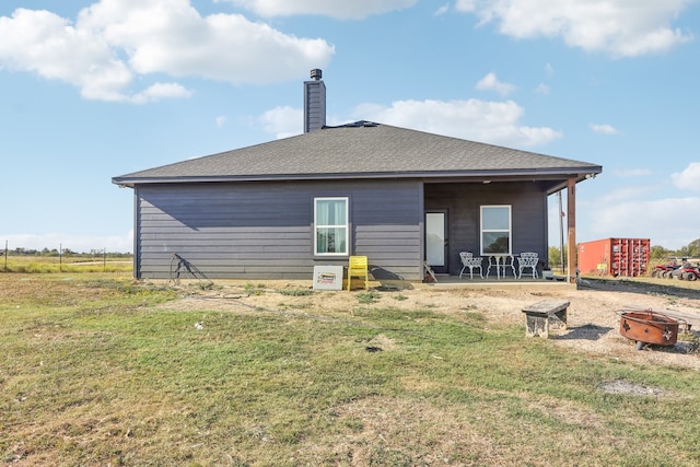 back of house with a lawn