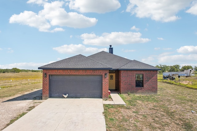 view of front of property featuring a garage and a front lawn