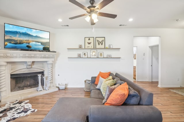 living room featuring hardwood / wood-style floors and ceiling fan