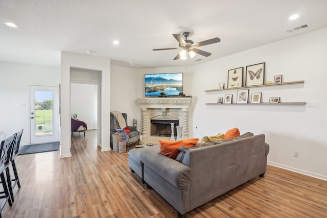 living room with hardwood / wood-style flooring and ceiling fan