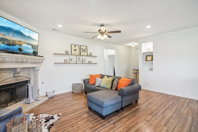 living room featuring hardwood / wood-style flooring and ceiling fan