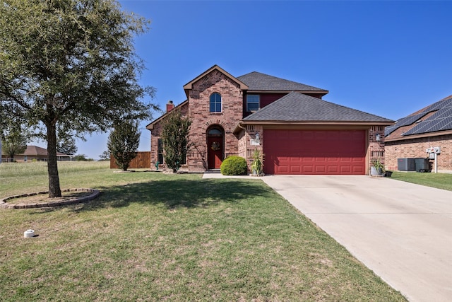 view of front facade with a front yard, a garage, and central AC