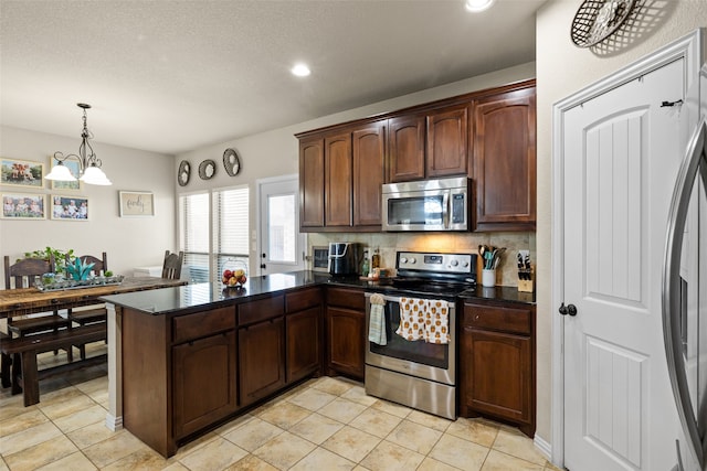 kitchen with decorative backsplash, dark brown cabinetry, decorative light fixtures, stainless steel appliances, and kitchen peninsula