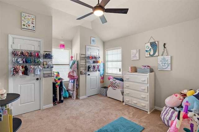 bedroom with ceiling fan, light colored carpet, and vaulted ceiling