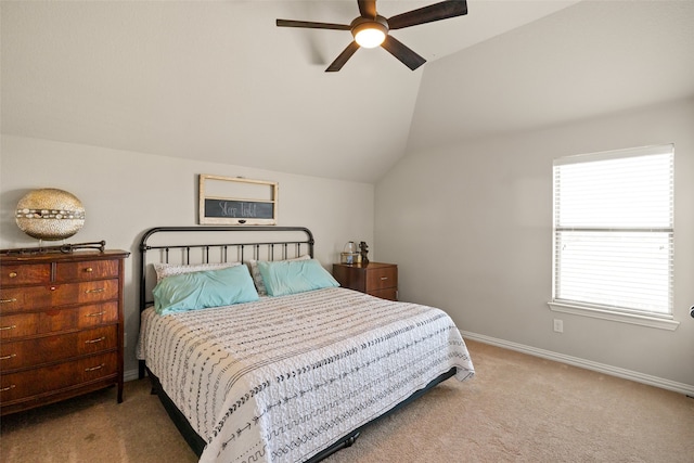 bedroom with ceiling fan, vaulted ceiling, and carpet flooring