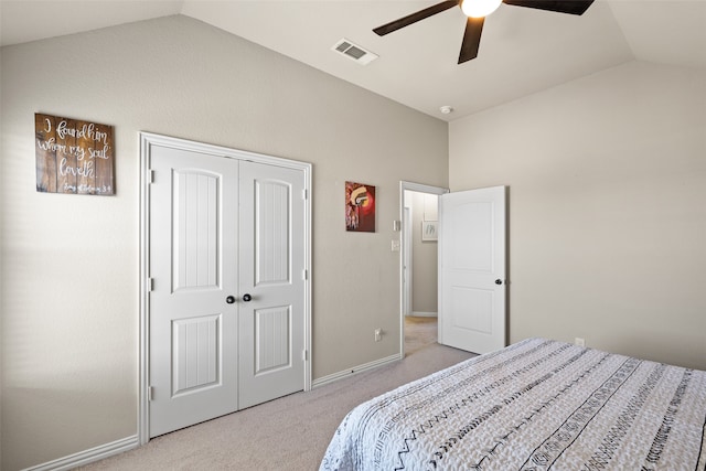 bedroom with light carpet, a closet, vaulted ceiling, and ceiling fan