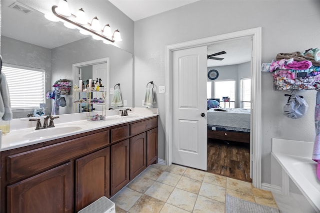 bathroom featuring a bath, hardwood / wood-style floors, vanity, and ceiling fan