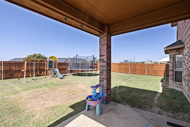 view of yard featuring a playground, a trampoline, and a patio area