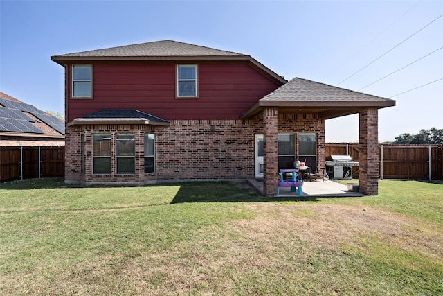 back of house with a yard and a patio area