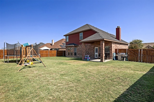 view of yard with a trampoline, a playground, and a patio area