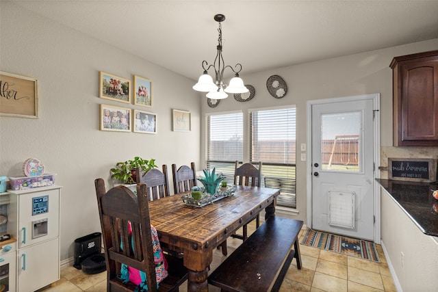 dining room with an inviting chandelier and light tile patterned flooring