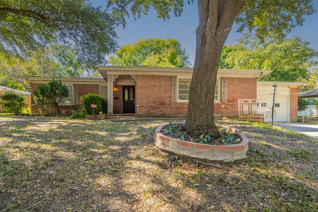 ranch-style home with a porch and a garage