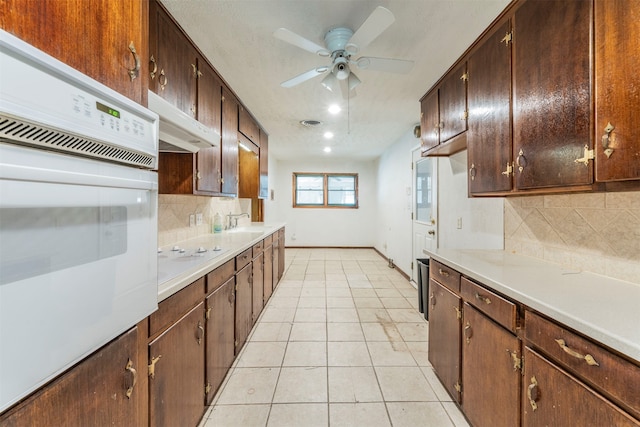 kitchen with white appliances, sink, backsplash, ceiling fan, and light tile patterned floors